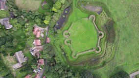 Aerial video footage of the remains of Bolingbroke Castle a 13th century hexagonal castle, birthplace of the future King Henry IV, with adjacent earthwork. and views of Old Bolinbroke Village.