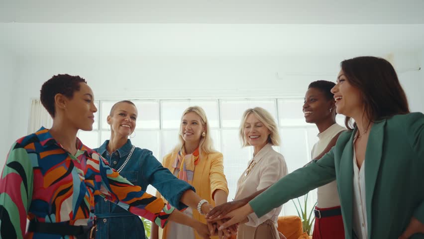 Cinematic footage of a multiethnic group of women managing new projects in a start up business. Female colleagues working as a team in the office wearing elegant colored diverse outfits Royalty-Free Stock Footage #1109940373