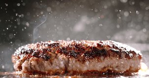 Beef cutlet for halal burger fried in frying pan. Cinematic advertising burger cooking. Well-fried cutlet in frying pan, fragrant steam, splashes of hot bubbling fat. Close-up of delectable cutlets