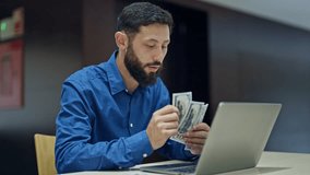 Young hispanic man business worker doing video call counting dollars at the office