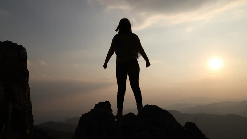Silhouette of a young woman standing with arms spread out. Homeopathy Good health. Confess your sins and hope to praise God. Royalty-Free Stock Footage #1109947443