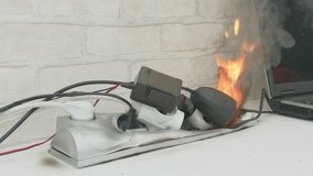 Overloaded power cube on fire on table indoors close up, voltage overload. Lot of electric plugs in sockets of power strip. - Powered by Shutterstock - Get 15% off with code: PIKWIZARD15