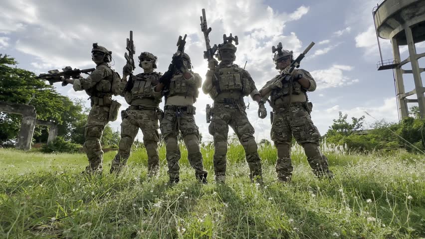 Soldier in full US MARSOC armed with assault rifle run through the abandoned building. Military clash.
