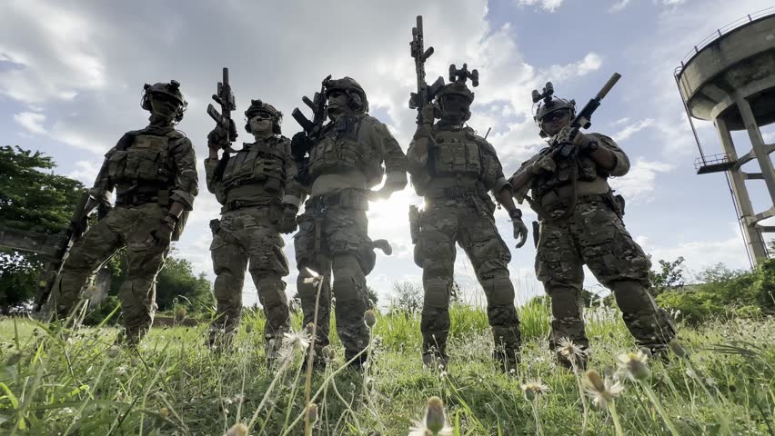 Soldier in full US MARSOC armed with assault rifle run through the abandoned building. Military clash.