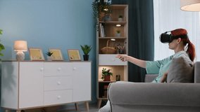 virtual communication with friends, a young woman wearing glasses uses modern technologies and communicates using a video call and augmented reality while sitting on sofa in room - Powered by Shutterstock - Get 15% off with code: PIKWIZARD15