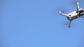 Drone equipped with camera flying under blue sky in background - Powered by Shutterstock - Get 15% off with code: PIKWIZARD15