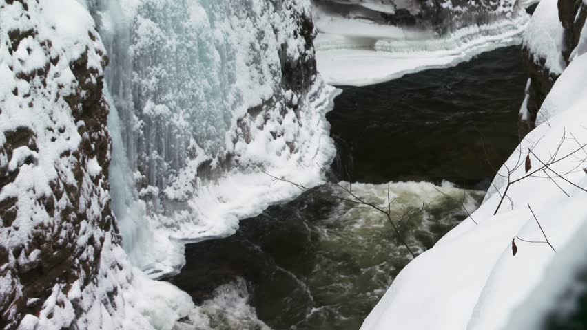 Mountain river running through ice covered gorge, Ausable Chasm in Adirondacks