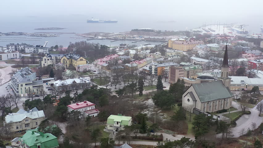 Hanko.Finland-January 3.2021: Awesome aerial shot of the port town of Hanko in Finland showing the church and the port in the background. Aerial shot with the drone slowly moving sideways.