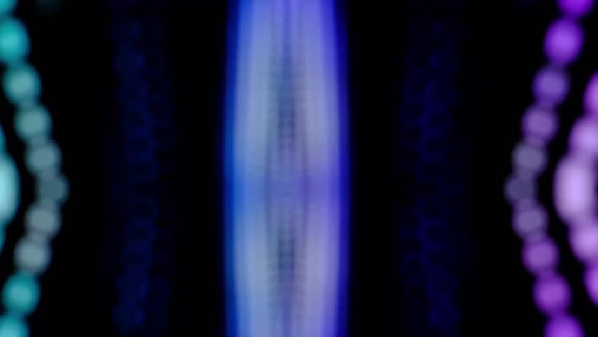 The background is a green, blue, yellow, purple electric flash running out on both sides, left and right, black background, good for use in shows or dramas.