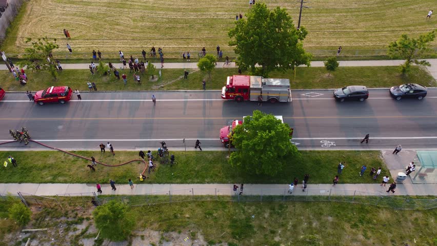 Group of people gather in their neighborhood due to presence of emergency teams fire trucks. Toronto, Canada