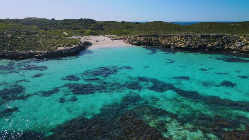 Aerial view above the sea, in the coast of Rottnest Island, Australia- forward, drone shot