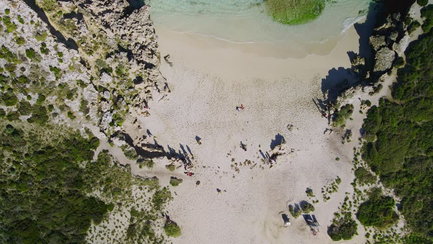 Aerial view over people in Salmon Bay, Rottnest Island, Australia- forward birds eye, drone shot