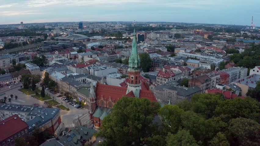 Kraków (often spelled Cracow in English), is the second-largest and one of the oldest cities in Poland. 
Drone video shot. Panorama of the evening city of Krakow. Sunset. Twilight.