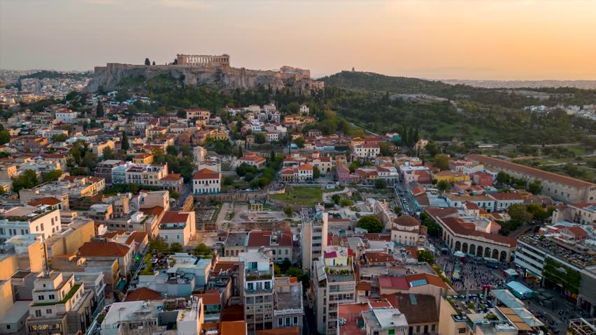 Aerial hyper lapse view of the skyline of Athens, Greece, with old town Plaka, Monastiraki square and the Acropolis during sunset