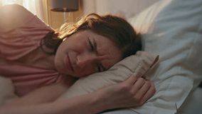 Annoyed girl turning alarm clock off closeup. Upset sleepy woman waking up early morning in sunlight. Unhappy female teenager checking snoozing mobile phone in cozy bed. Weekdays routine lifestyle. - Powered by Shutterstock - Get 15% off with code: PIKWIZARD15