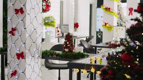 Dolly in close up shot on mini Christmas pine tree decoration placed in empty office. Festive workplace filled with xmas lights, garlands and wreaths during winter holiday season - Powered by Shutterstock - Get 15% off with code: PIKWIZARD15