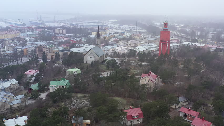 Hanko.Finland-January 3.2021: Beautiful aerial shot of the city landscape in Hanko Finland showing the church and the water tower. Aerial shot with the drone slowly moving forward.