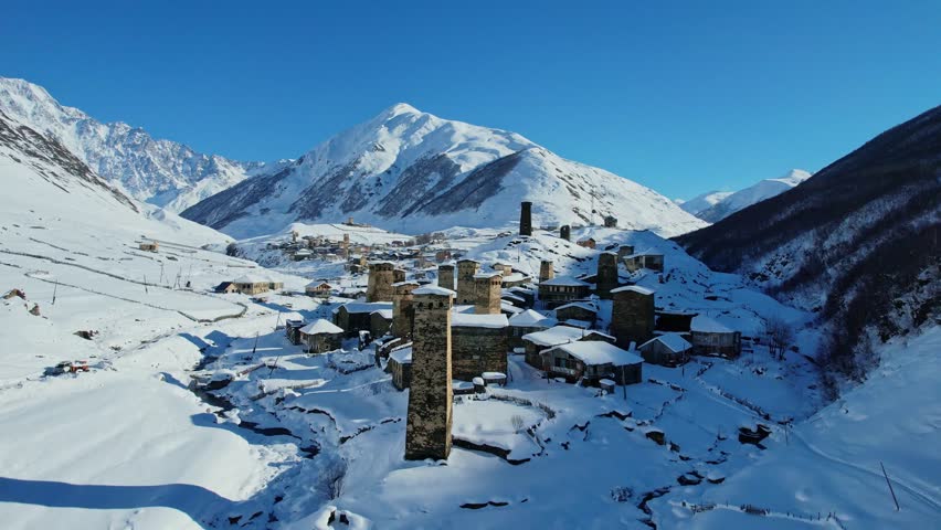 Medieval Stone Tower Town in Caucasus Nature Mountains, Rivers, and Valleys In North East Of Europe In Mestia Svaneti Georgia. Winter Historical Old Village Landscape Of Ushguli Covered With Snow.  Royalty-Free Stock Footage #1109987587