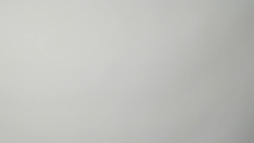 Hand giving red apple, white background. Hand with red apple, close-up 4k slow motion