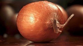 The knife cuts the onion in half. Filmed on a high-speed camera at 1000 fps. High quality FullHD footage