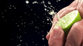 Squeezing lime juice with splashes. Filmed on a high-speed camera at 1000 fps. High quality FullHD footage - Powered by Shutterstock - Get 15% off with code: PIKWIZARD15