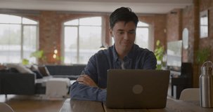 Young adult male working from home on a video call