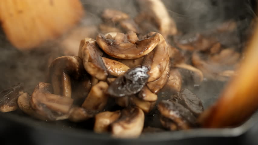 Stirring and fry champignons mushrooms in pan Royalty-Free Stock Footage #1109996031