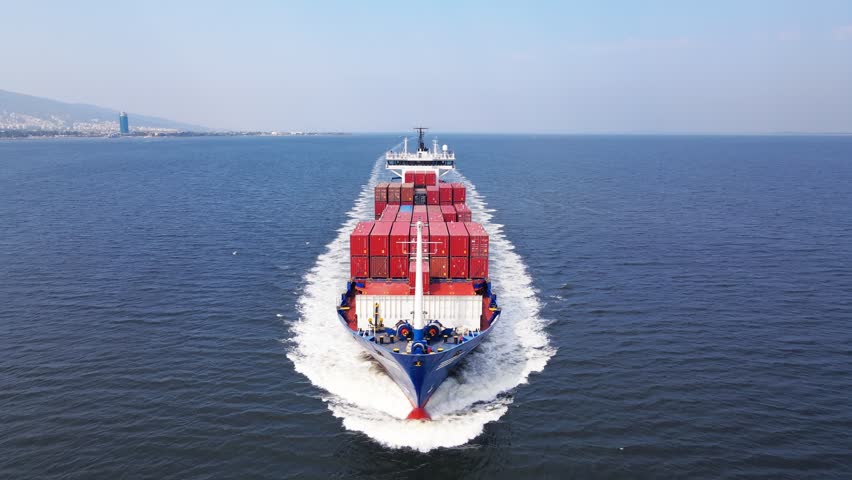 Aerial view of fully loaded container ship cruising open ocean sea for logistics import export, shipping or transportation