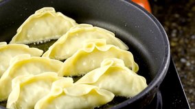 4K Video of Cooking Pot Stickers on a Frying Pan