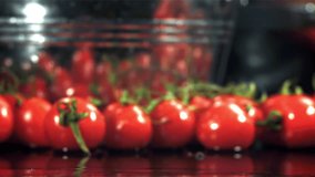 Tomatoes fall on a wet table. Filmed on a high-speed camera at 1000 fps. High quality FullHD footage