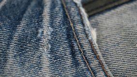 closeup rotation of the frayed texture of the pocket edge of worn old blue jeans. the concept of recycling old jeans. - Powered by Shutterstock - Get 15% off with code: PIKWIZARD15