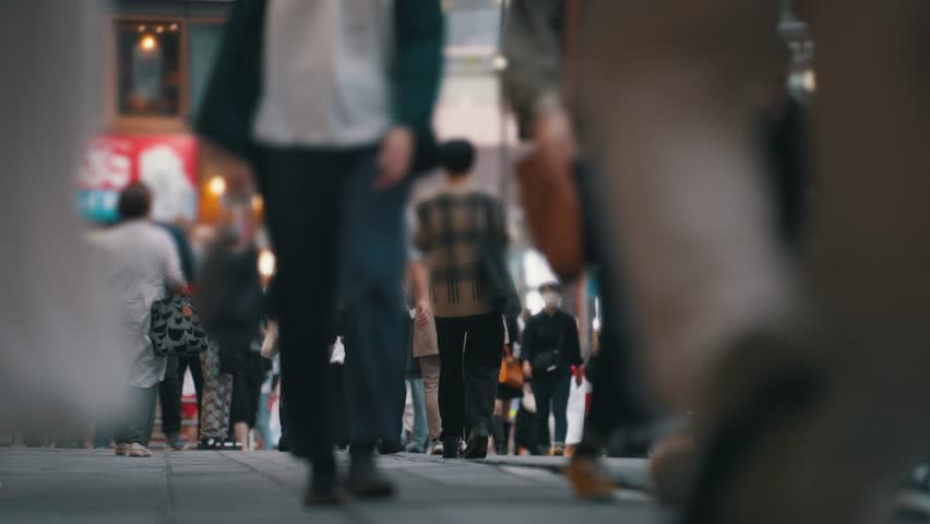 A lot of people are walking the street. Crowd of people walking down the pavement. Crowded avenue. Society and city life concept. City lifestyle concept