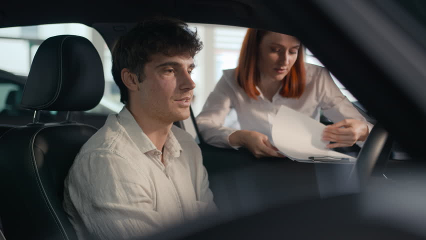 Caucasian seller woman female automobile salon manager trader saleswoman consult client male buyer man helping businessman choose auto explain trade new car to customer guy sit inside vehicle rent Royalty-Free Stock Footage #1110014617