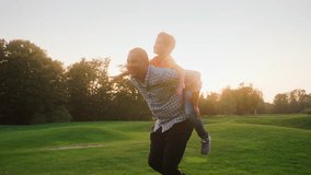 Multiracial mature father joyfully running across sunlit field with young son on his back. Cheerful school boy imitating an airplane with open hands during summer weekends with loving daddy. - Powered by Shutterstock - Get 15% off with code: PIKWIZARD15