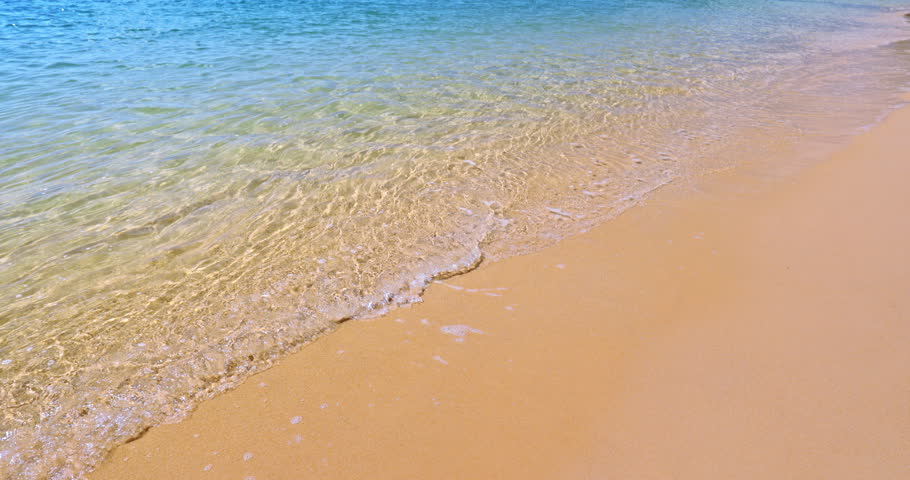 Crystal clear sea water on beach front of tropical ocean coast