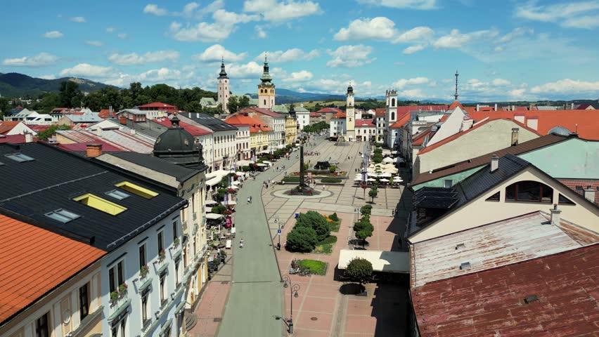 Banska Bystrica cityscape in summer, Slovakia. Flight over of old town, small medieval town in central Slovakia. Drone forward dolly Aerial view of the main Slovak National square.