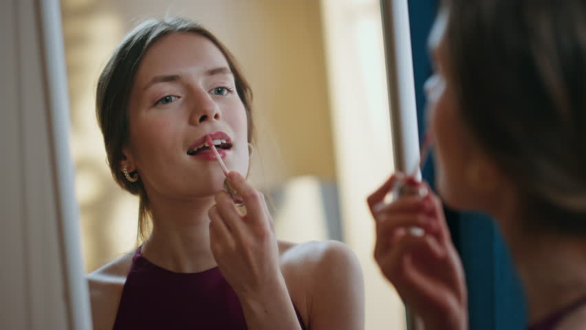 Gorgeous girl applying lipstick in mirror reflection closeup. Joyful model enjoy beauty routine admiring makeup at home. Happy relaxed woman get ready preparing for romantic date. Femininity concept Royalty-Free Stock Footage #1110017709