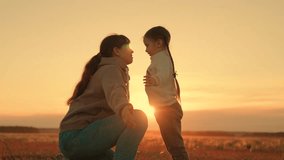 Child playing with mom happy hugs. Family in park in summer. Little child playing with parent. Happy family hugging in front of sun. Carefree childhood, joyful hugs of baby and mother in park, sunset - Powered by Shutterstock - Get 15% off with code: PIKWIZARD15