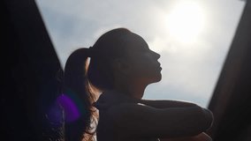 Closeup silhouette of healthy young woman athlete wearing sportwear doing aerobic exercises, stretching shoulder and neck muscles, standing on background of bright sunlight on summer sunny morning. - Powered by Shutterstock - Get 15% off with code: PIKWIZARD15
