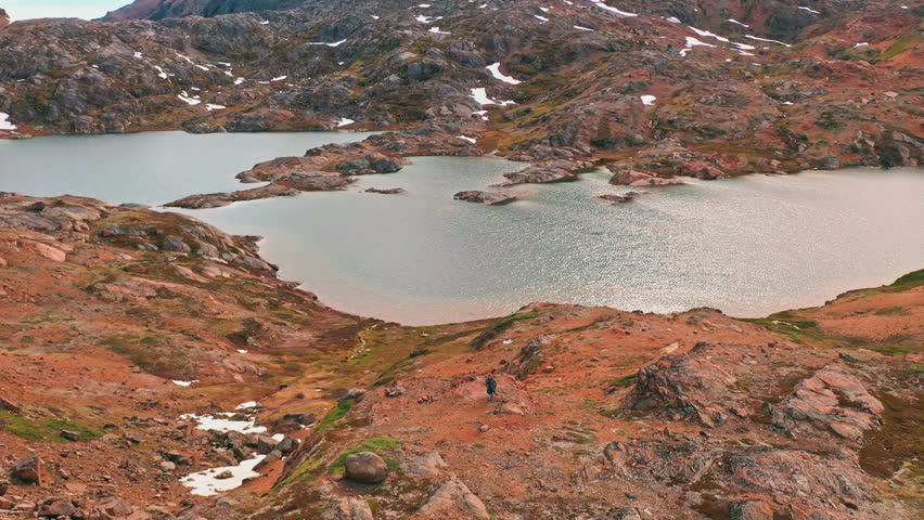 Greenland rocks with sea and snow