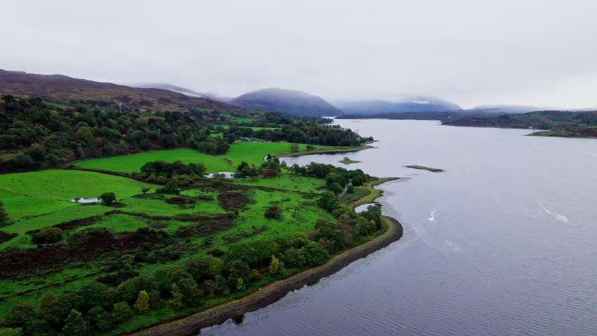 Aerial view travelling over Loch Etive and surrounding countryside on a cloudy overcast day. Scotland