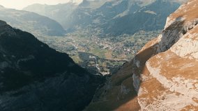 aerial drone footage of Grindelwald in th e distance flying between valley of EIger and Mattanberg