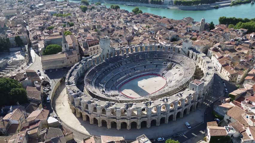 Aerial drone footage of Arles Amphitheatre France ancient Roman arena in historic Provence city center