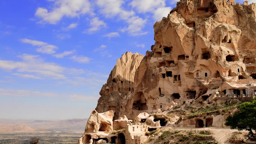 View of Uchisar Castle rock opposite bright blue sky. Cappadocia, Turkey. 