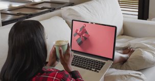 Biracial woman using laptop at home online shopping on cyber monday sale day, slow motion. Retail business, sale, communication and digital interface digitally generated video.