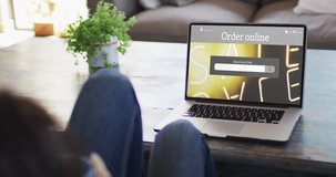 Knees of woman at table using laptop, online shopping during sale, slow motion. Retail business, sale and digital interface digitally generated video.