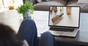 Knees of woman at table using laptop, online shopping for beauty products, slow motion. Retail business, sale and digital interface digitally generated video.