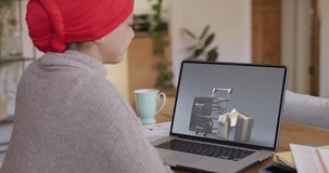 Biracial woman at table using laptop, shopping online on cyber monday, slow motion. Retail business, sale, communication and digital interface digitally generated video.