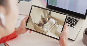 Caucasian woman using tablet, online shopping for beauty products, slow motion. Retail business, sale and digital interface digitally generated video.