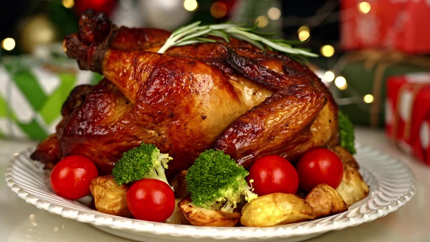 Place plates and grilled chicken on the Christmas table